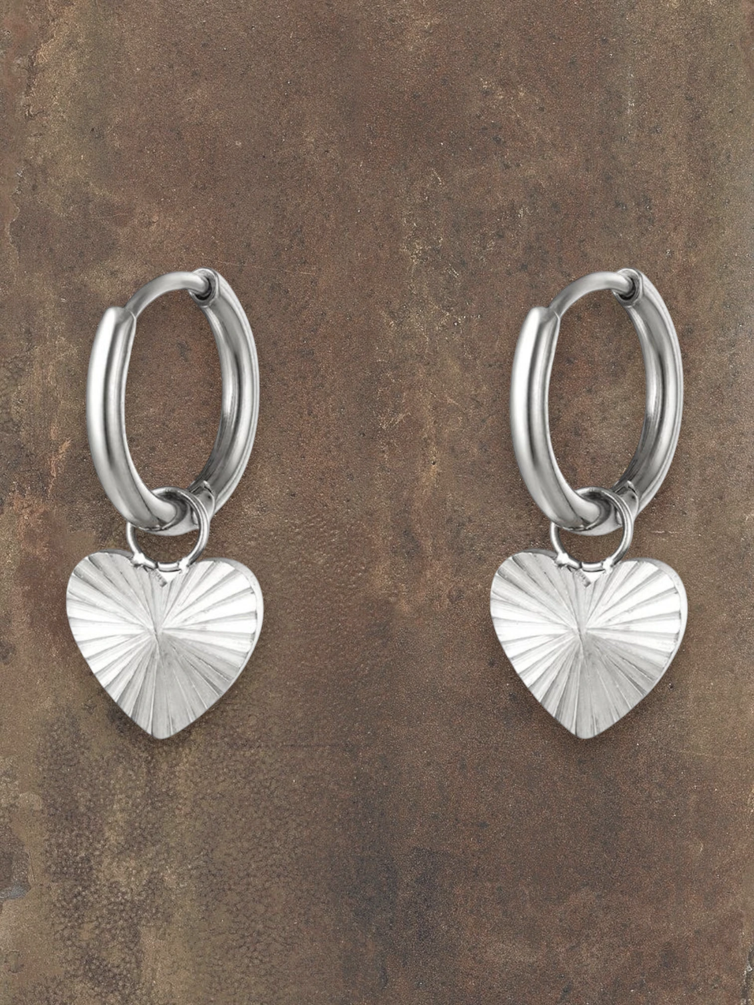 WILDSIDE silver-tone metal hoop earrings with textured heart charms. Perfect for everyday wear.