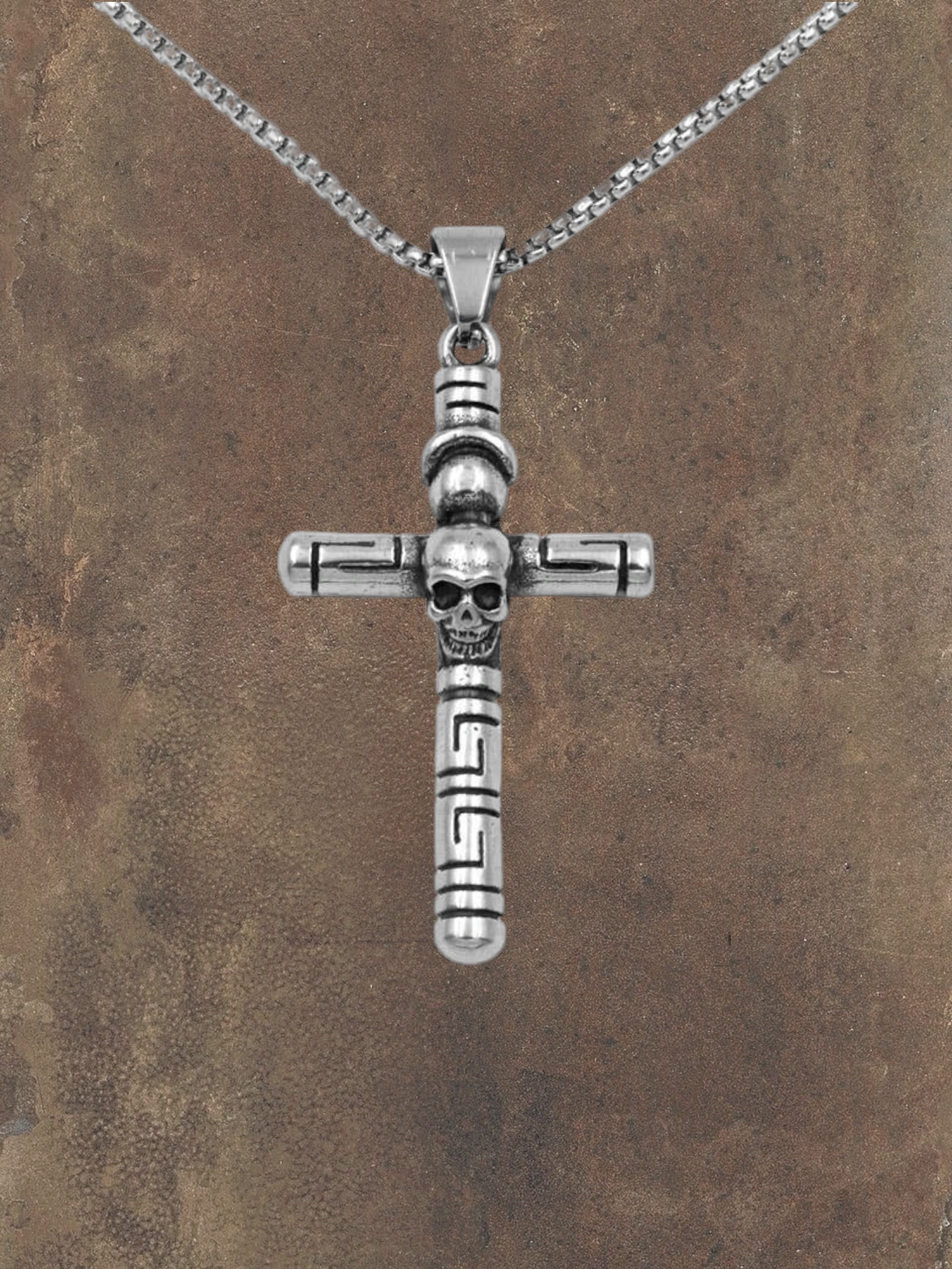 WILDSIDE silver-tone stainless steel cross pendant with skull detail and Greek key pattern. Hand-polished.