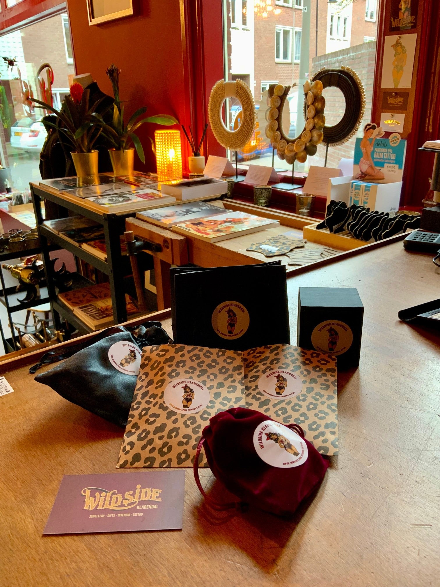 WILDSIDE gold hoop earrings with pearl drop, presented in velvet pouch and leopard print packaging.