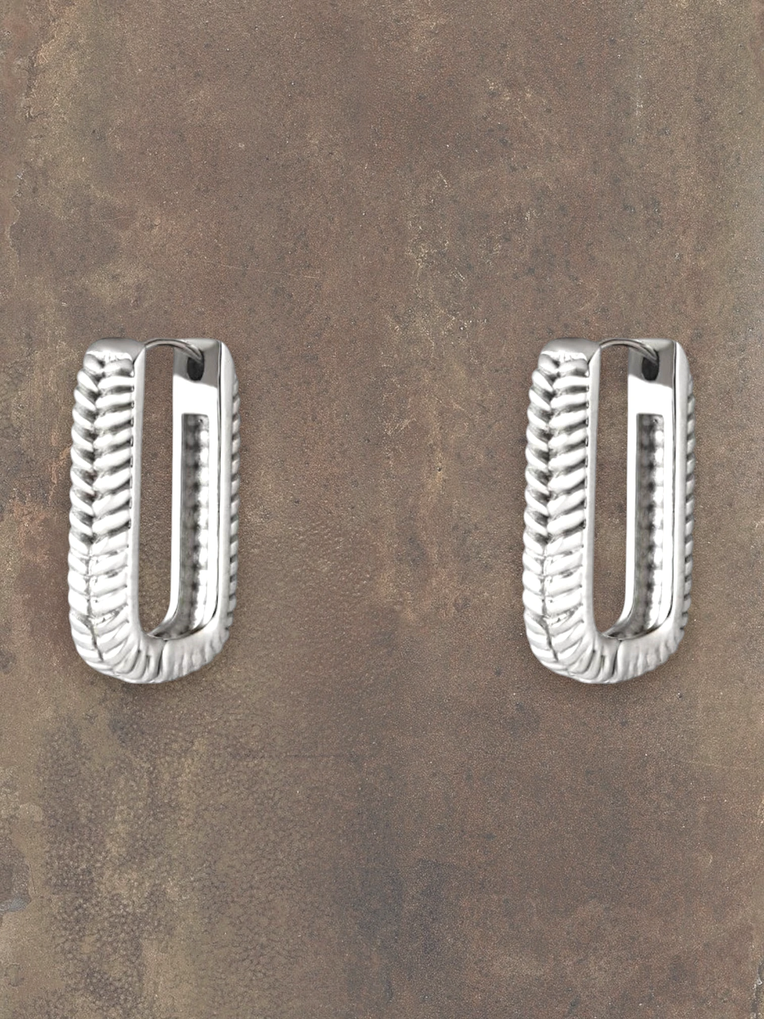 WILDSIDE silver rectangular hoop earrings with a textured rope design. Modern statement jewelry.