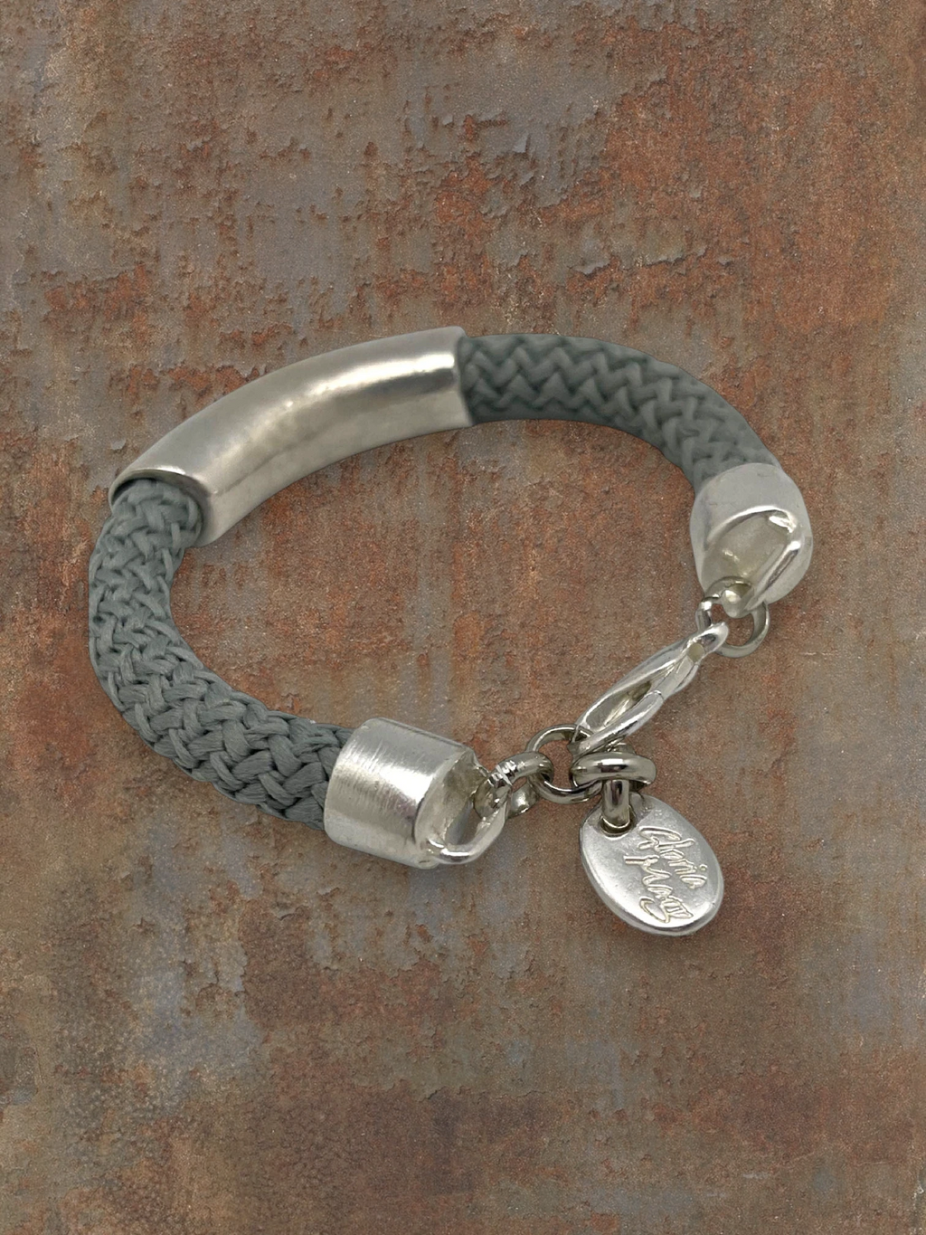 WILDSIDE gray cotton cord bracelet with silver-plated zamak tube and lobster clasp. Exclusive design.
