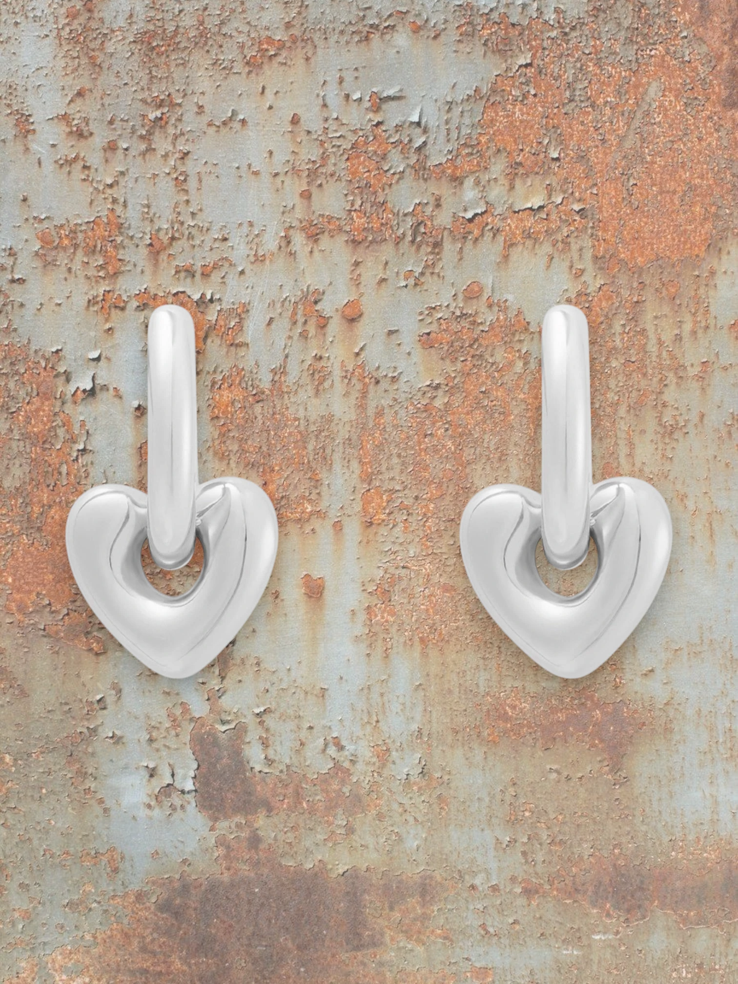 WILDSIDE silver steel heart shaped drop earrings with a modern sculpted design and sleek hoop.