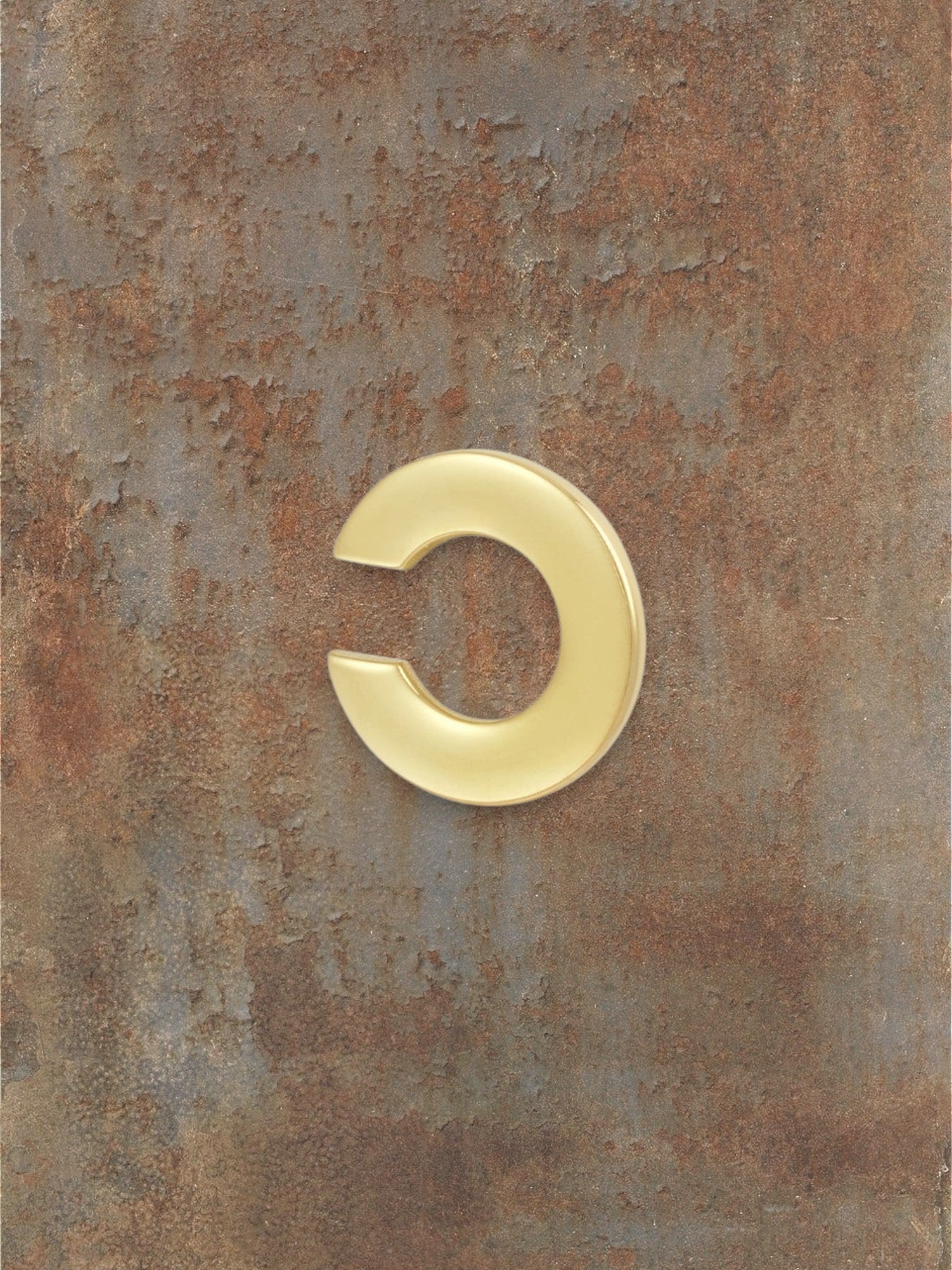 WILDSIDE polished gold-tone metal curved ear cuff. Minimalist, non-piercing design.