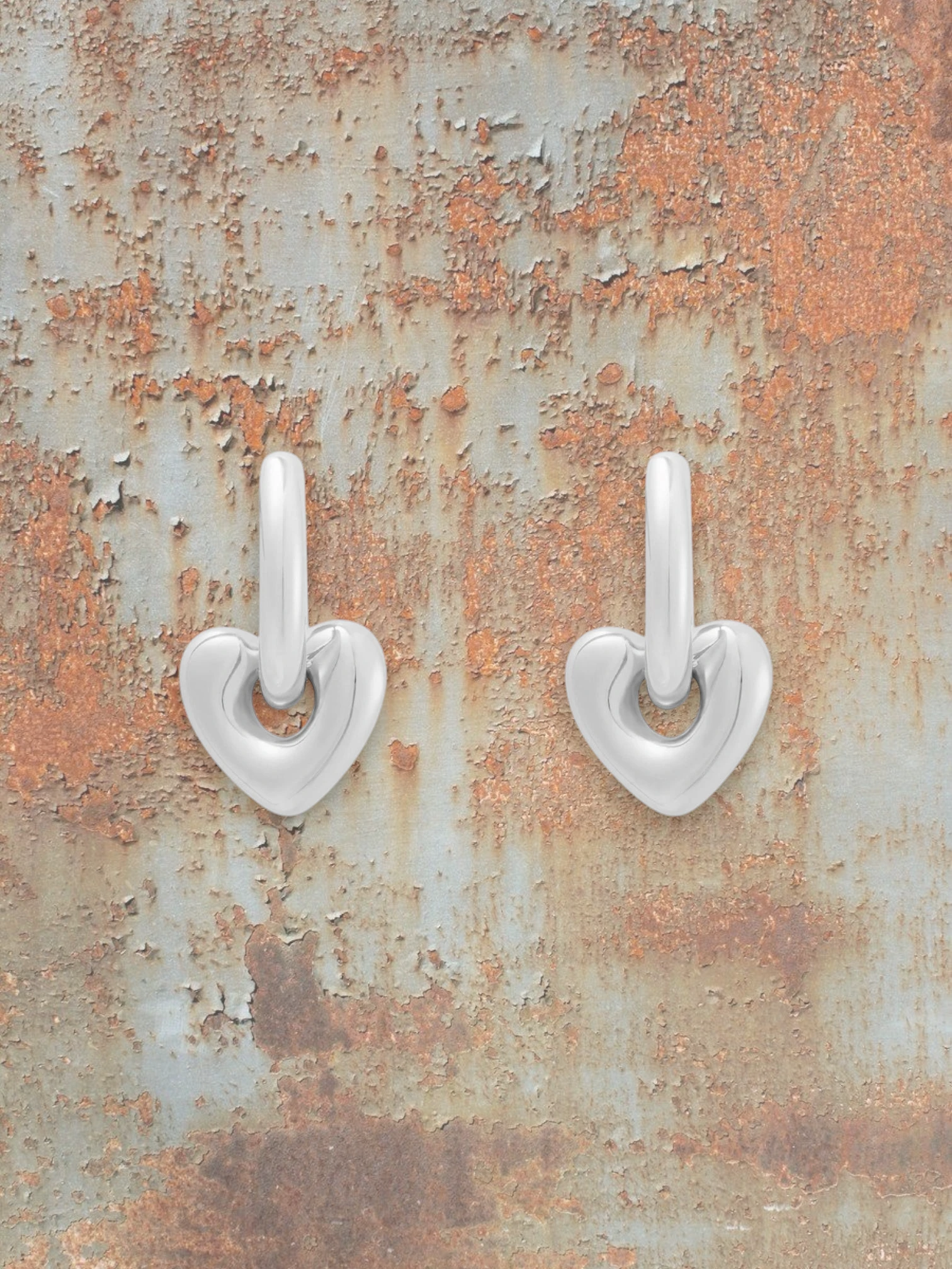 WILDSIDE polished silver steel heart shaped drop earrings with sleek hoops.