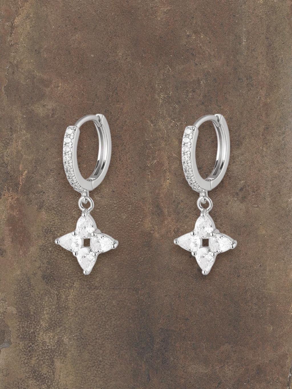 WILDSIDE silver steel huggie hoop earrings with sparkling cubic zirconia flower drops.