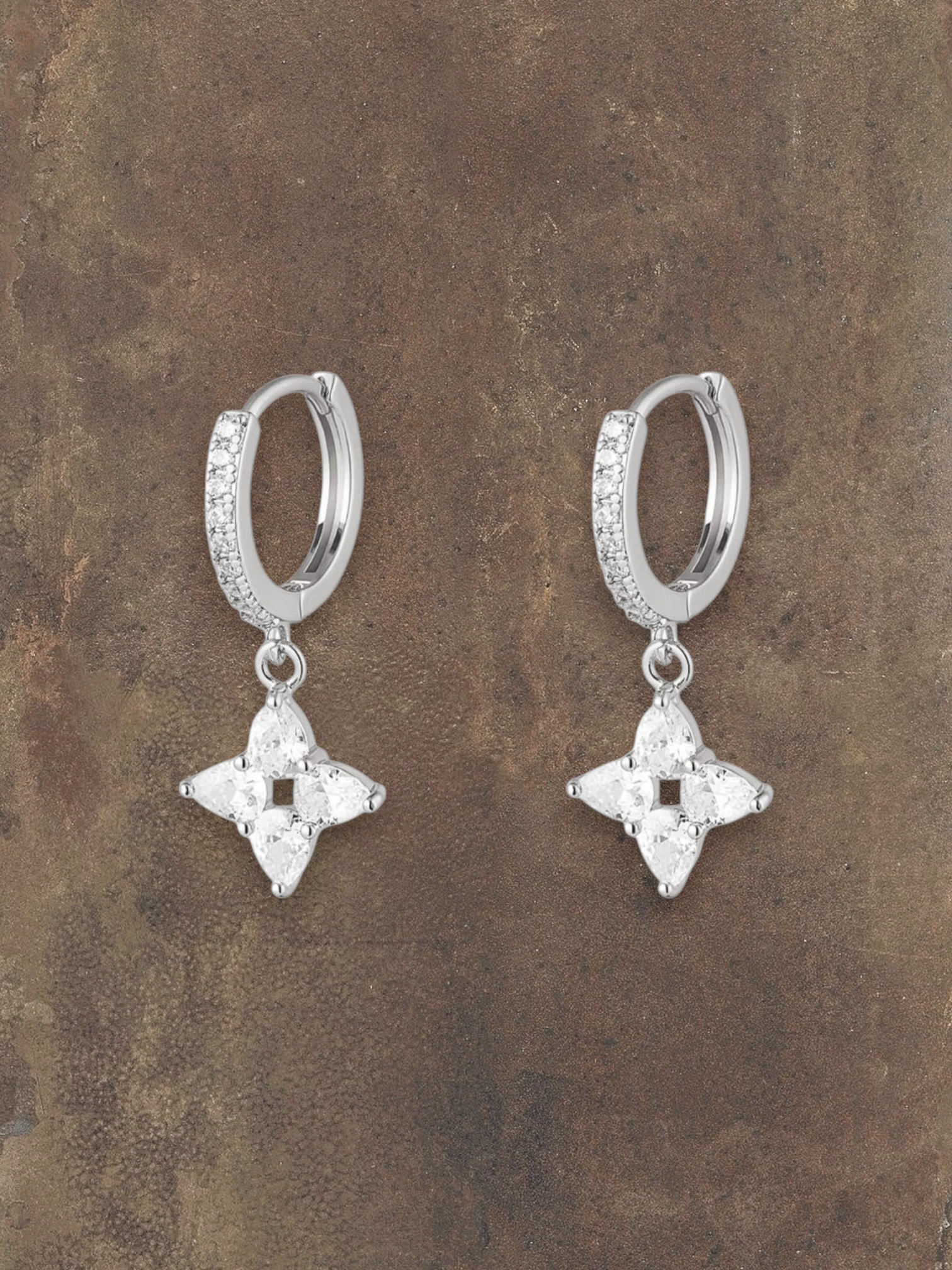 WILDSIDE silver steel huggie hoop earrings with sparkling cubic zirconia flower drops.