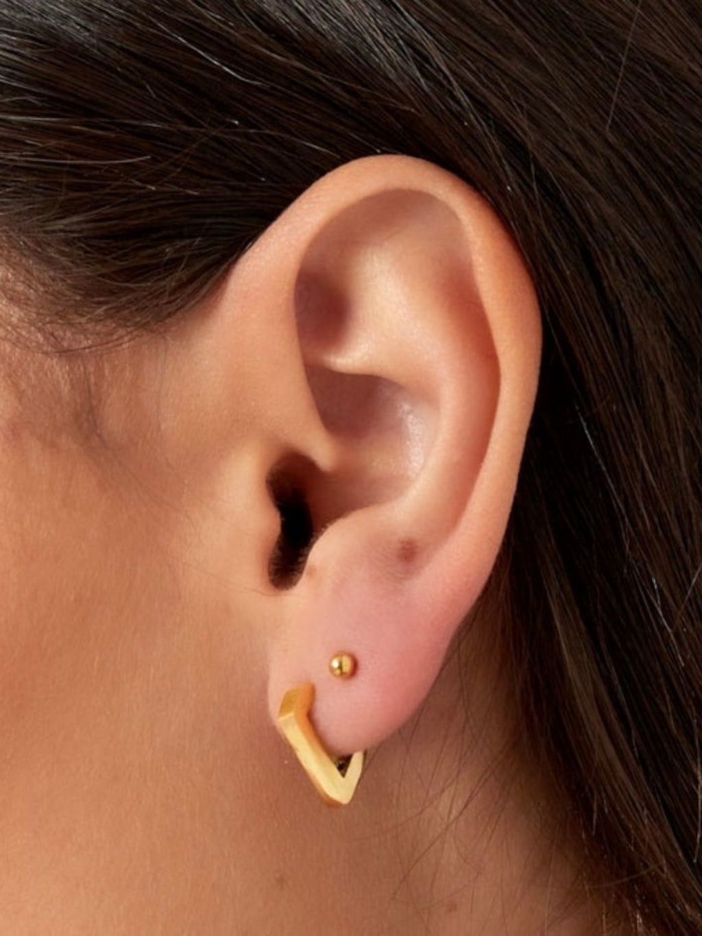 WILDSIDE gold geometric diamond hoop earrings with a polished finish and a small stud earring.