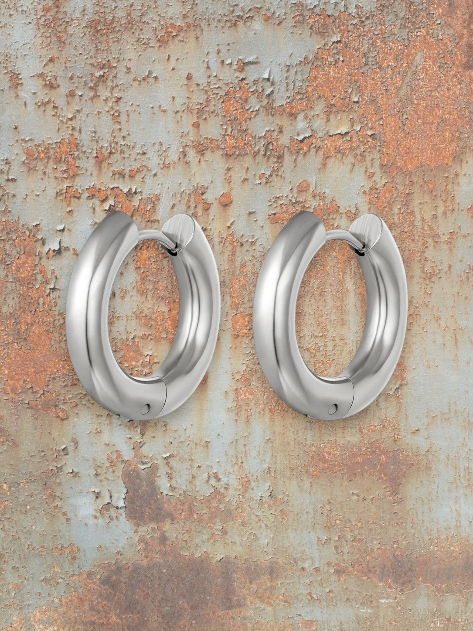 WILDSIDE medium thick polished metal hoop earrings in silver. Classic, bold, and sophisticated.