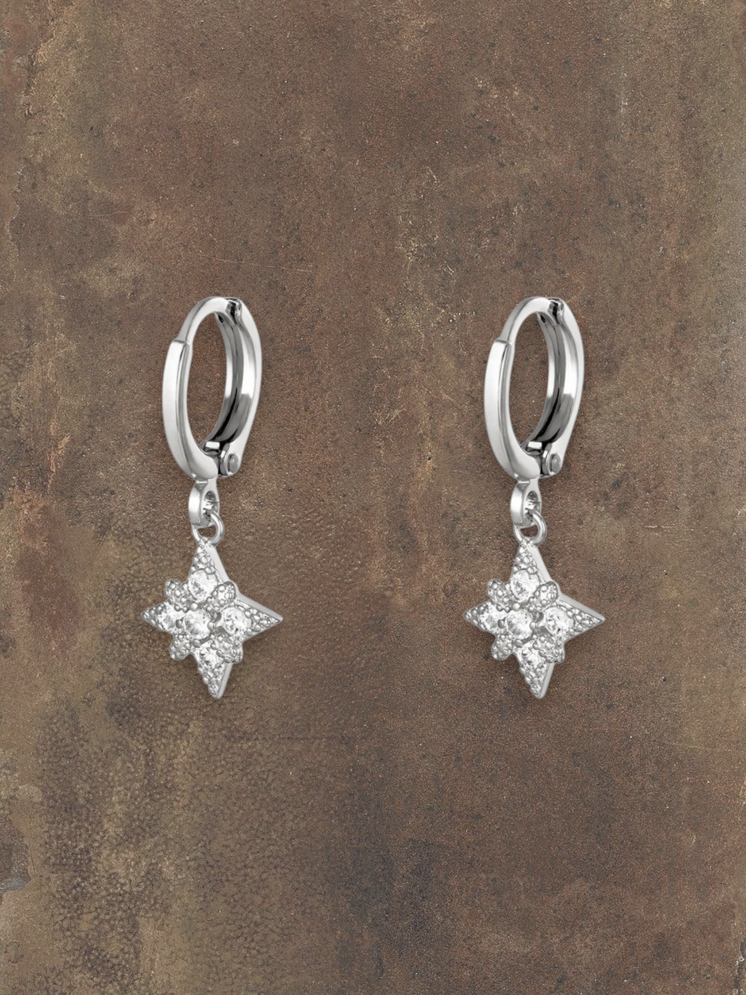 WILDSIDE silver steel hoop earrings with sparkling cubic zirconia starburst charms.