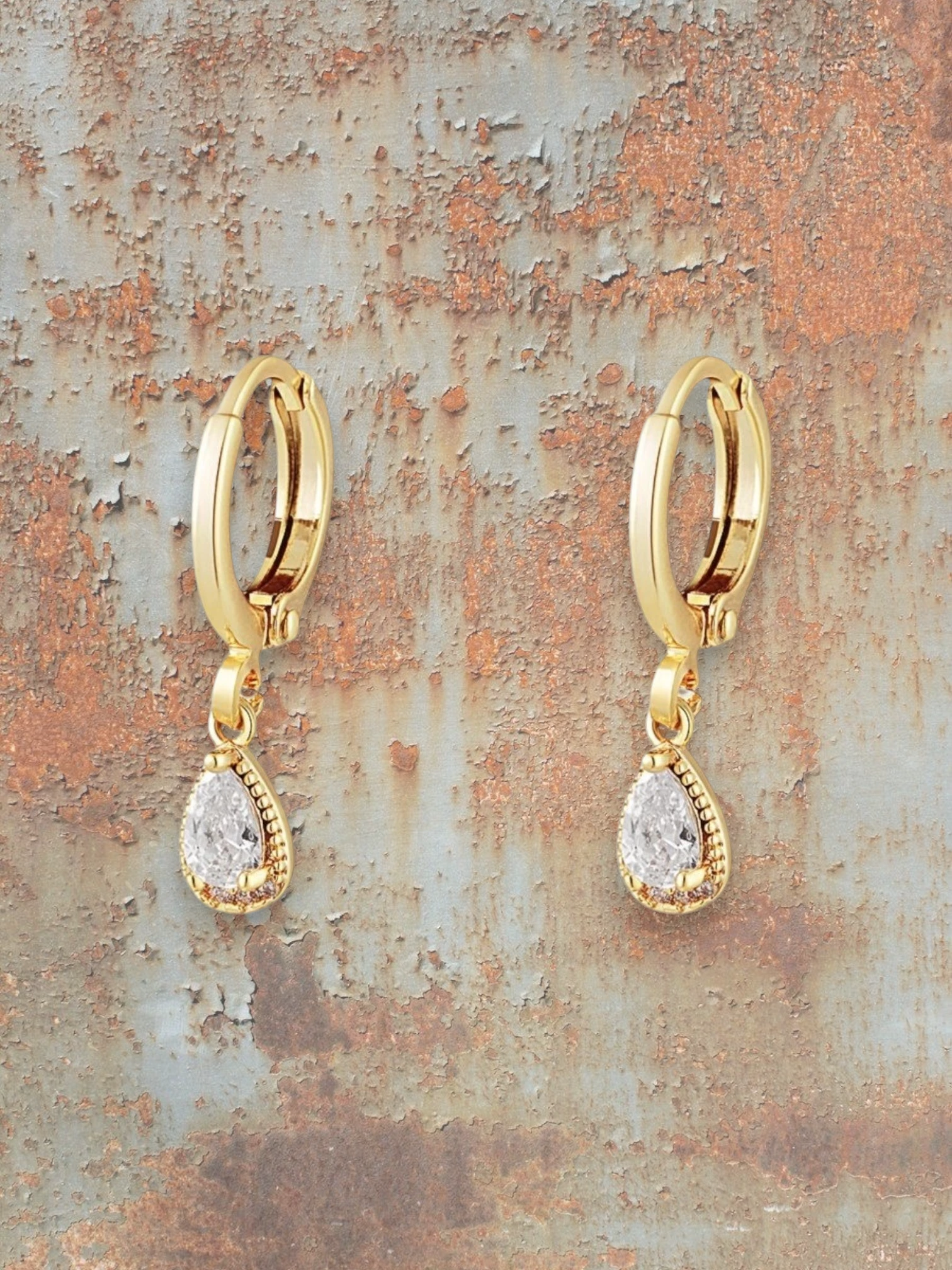 WILDSIDE gold-tone teardrop gemstone hoop earrings with clear cubic zirconia pendants and vintage detailing.