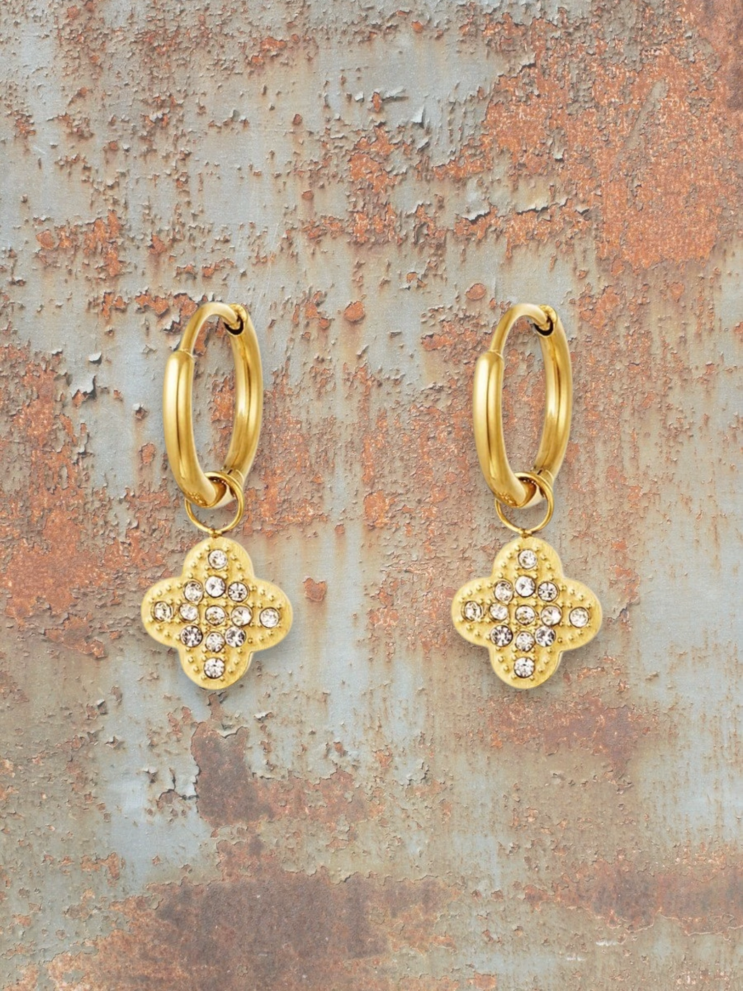 WILDSIDE gold-tone hoop earrings with sparkling cubic zirconia clover charms.