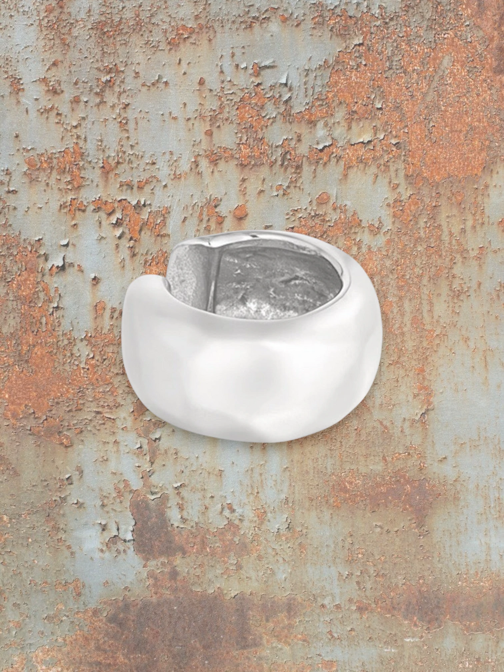 WILDSIDE sculptural ear cuff in polished metal with a smooth, curved, organic shape. No piercing needed.