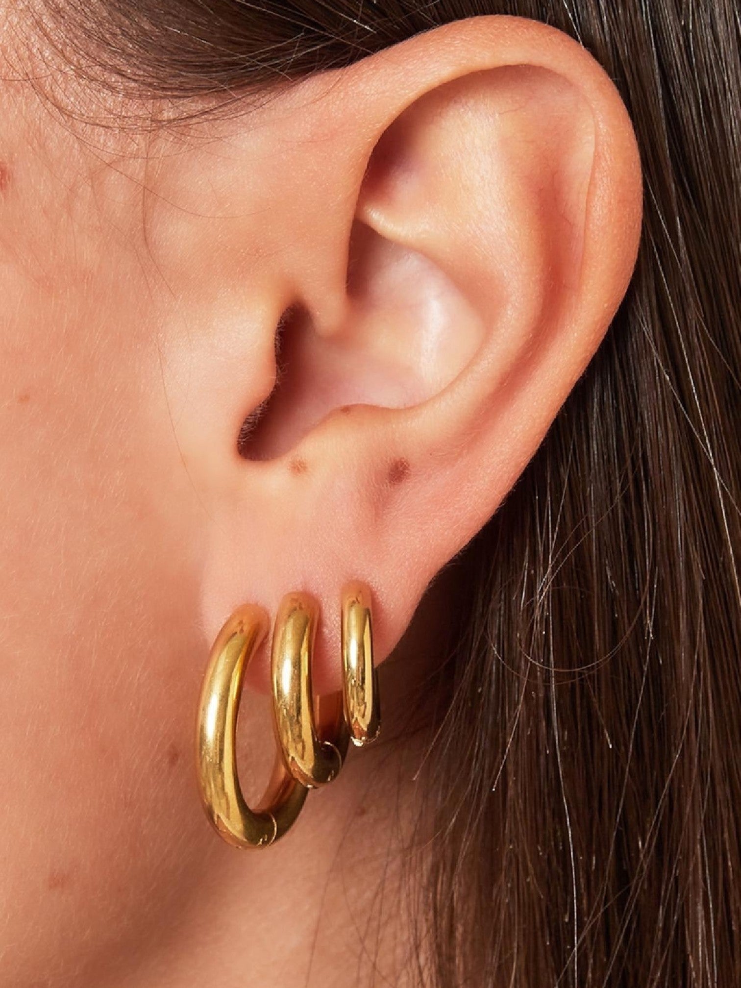 WILDSIDE medium chunky hoop earrings in polished gold-tone metal. Set of three graduated hoops for versatile styling.