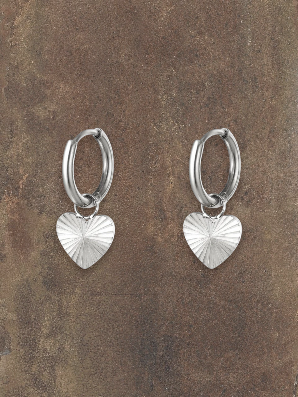 WILDSIDE silver-tone metal hoop earrings with textured heart charms. Perfect for everyday wear.