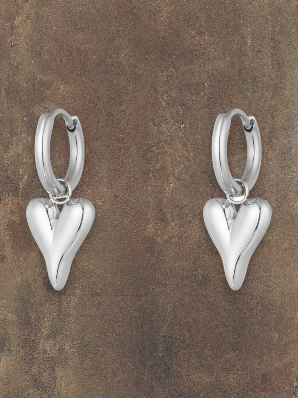 WILDSIDE silver steel puffy heart hoop earrings with polished finish. Classic hoops with dangling heart charms.