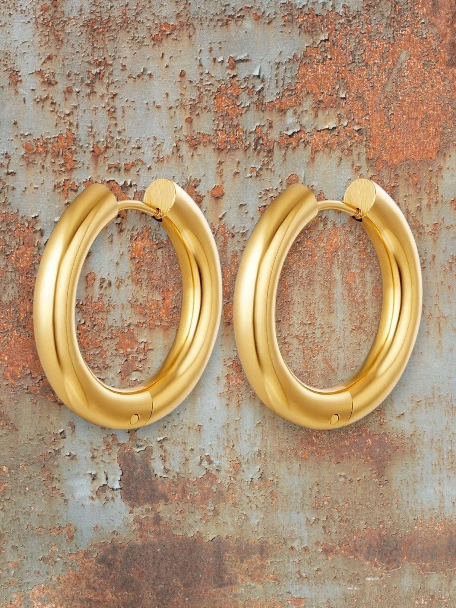 WILDSIDE polished gold-tone metal chunky hoop earrings. Bold, sophisticated, and versatile for any occasion.