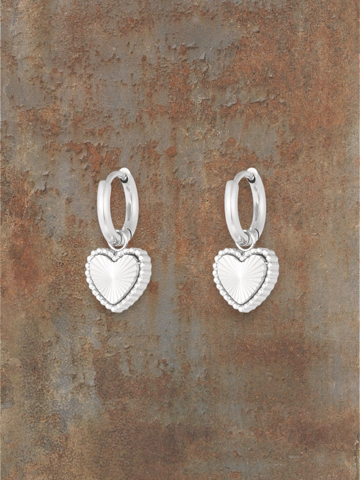 WILDSIDE silver-tone hoop earrings with textured heart charms, perfect for everyday wear.