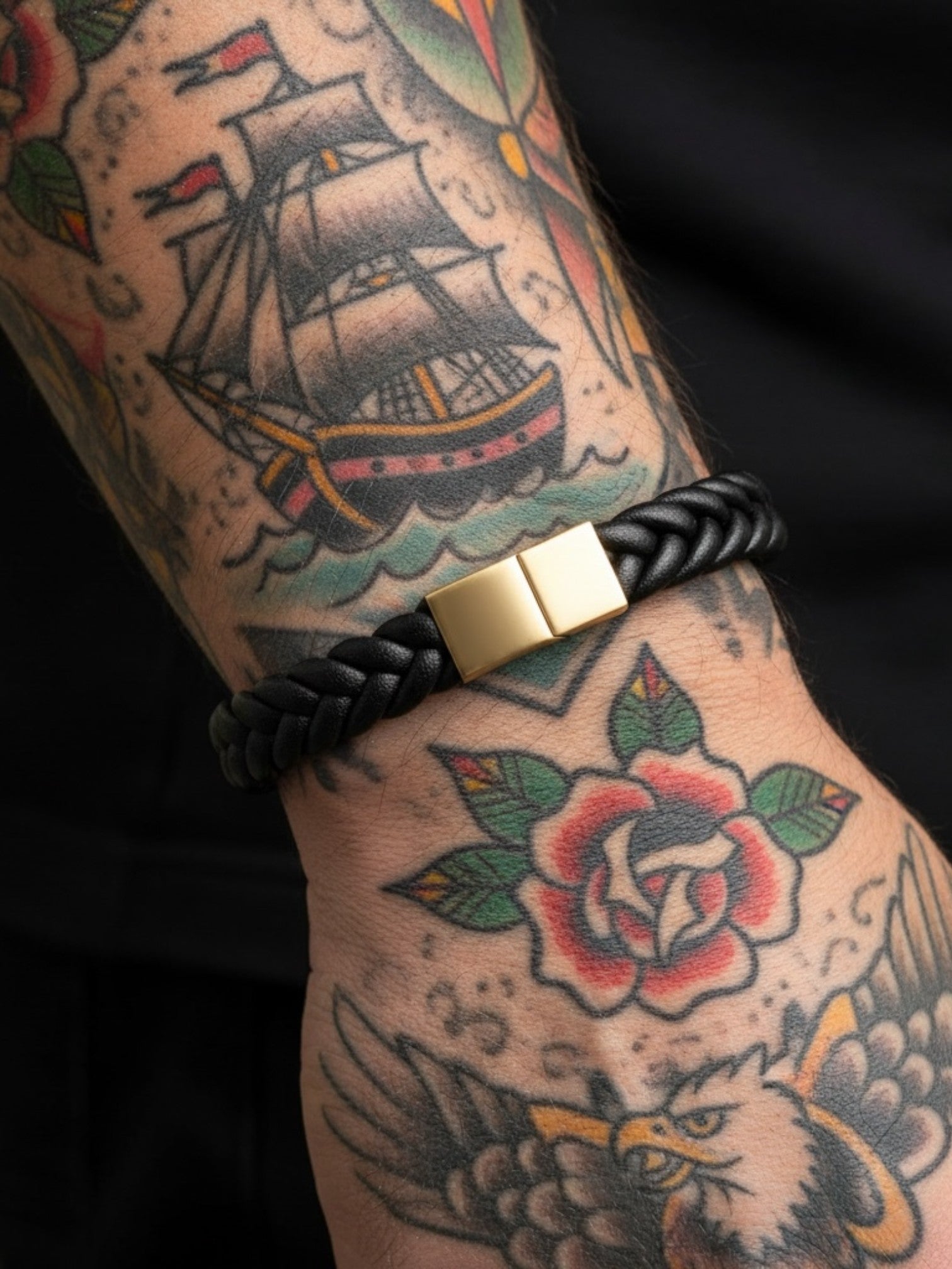 WILDSIDE black braided leather open cuff bracelet with gold magnetic clasp. Surgical steel detail.