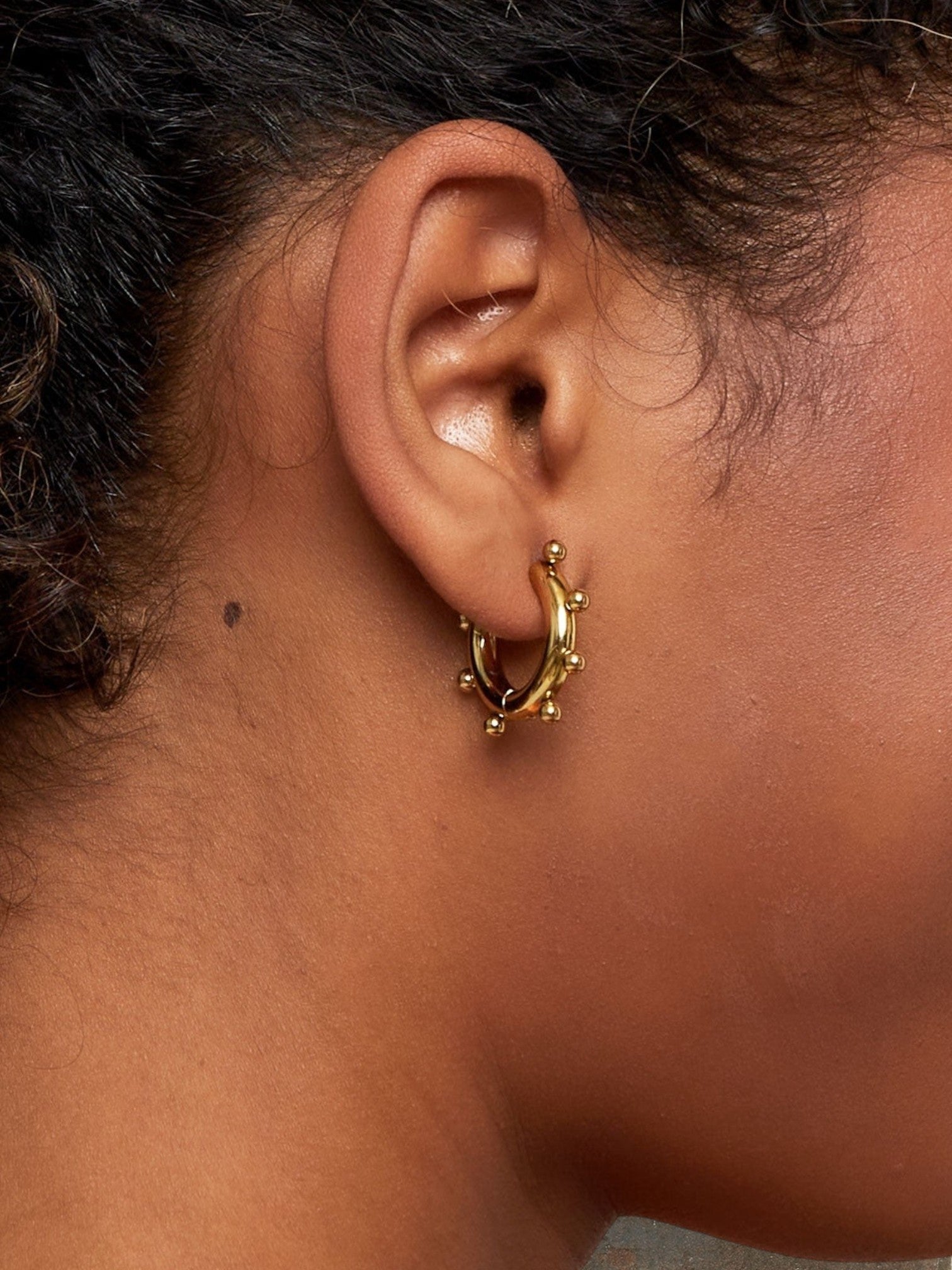 WILDSIDE gold-tone metal beaded hoop earrings with textured detail. Medium size, perfect for everyday wear.