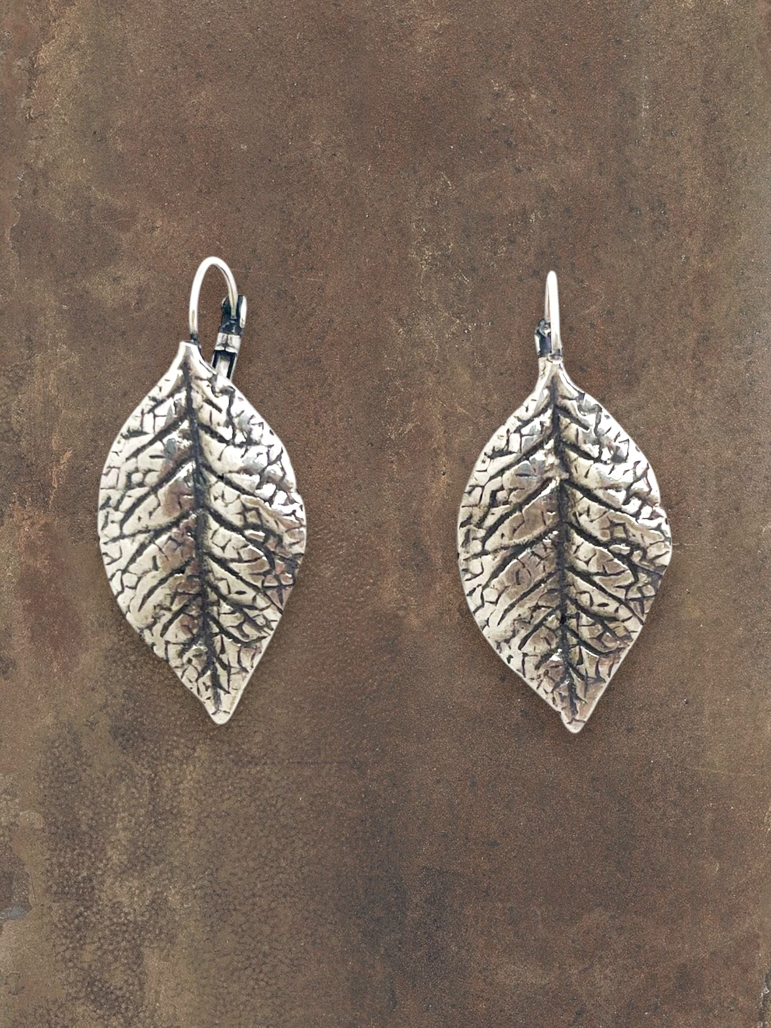 WILDSIDE - antique silver textured leaf drop earrings with intricate veining detail.