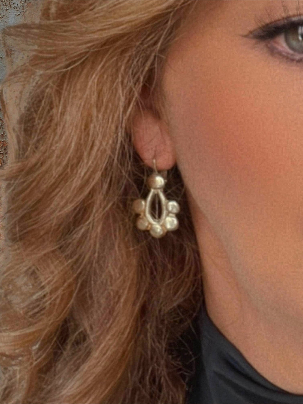 WILDSIDE polished metal geometric drop earrings with open teardrop design and rounded charms, lever-back closure.