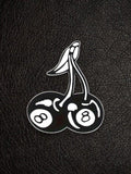 WILDSIDE black and white enamel pin shaped like cherries with 8-ball designs on each cherry.