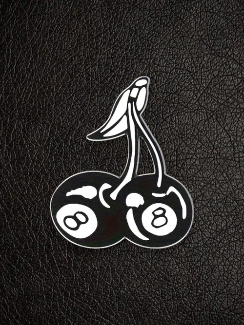 WILDSIDE black and white enamel pin shaped like cherries with 8-ball designs on each cherry.