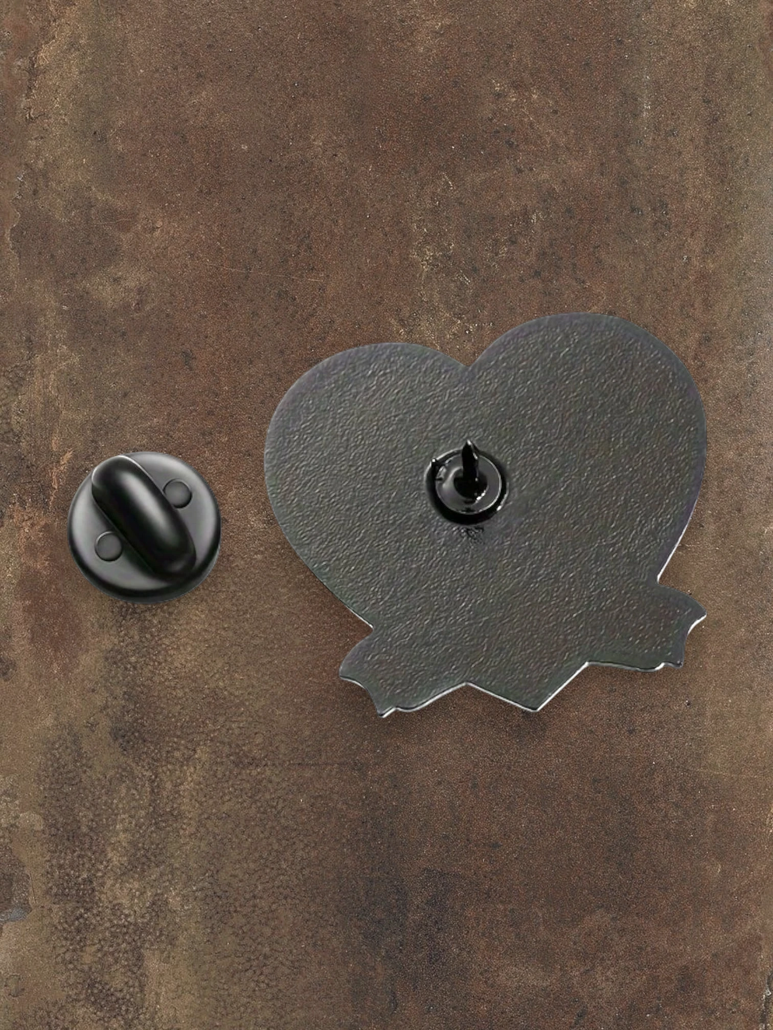 WILDSIDE Addams Family heart-shaped pin with a jagged edge, featuring a black metal backing and pin closure.
