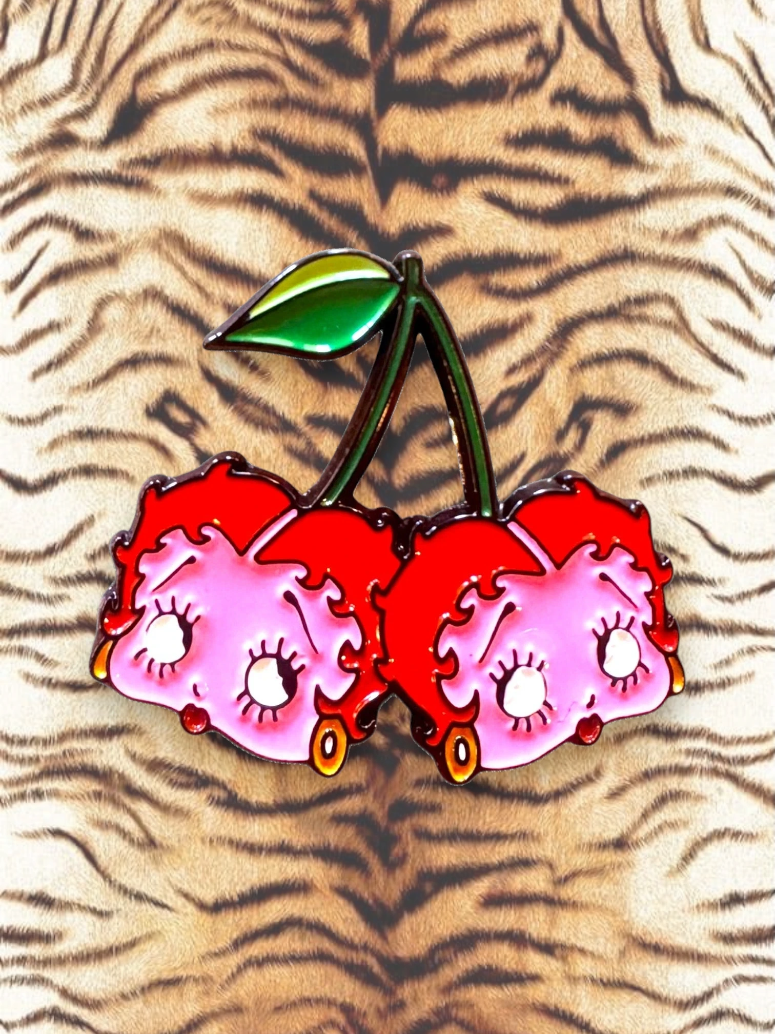 WILDSIDE Betty Boop cherry pin with pink faces, red hair, and a green leaf.