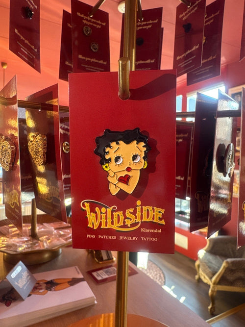 WILDSIDE Betty Boop enamel pin with black hair, red lips, and yellow earrings.