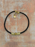 WILDSIDE black braided leather necklace with gold-tone zamak beads and clasp. Adjustable length.