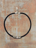 WILDSIDE black braided leather necklace with silver plated zamak beads and lobster clasp. Made in Spain.
