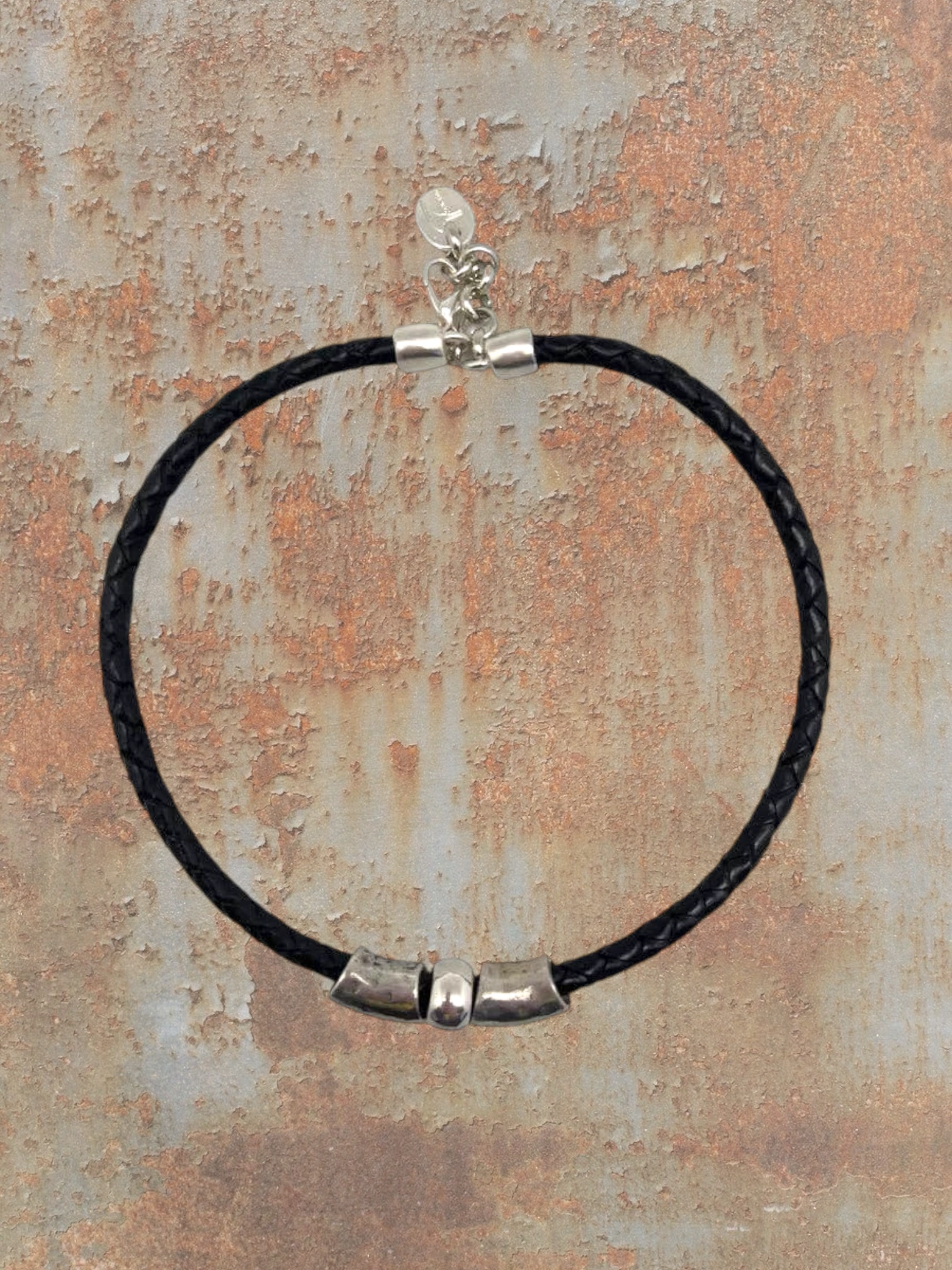 WILDSIDE black braided leather necklace with silver plated zamak beads and lobster clasp. Made in Spain.