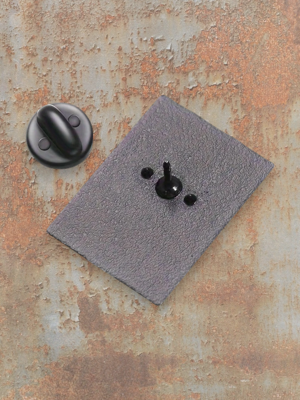 WILDSIDE black enamel pin with a textured grey backing and a black clutch.