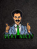 WILDSIDE Borat enamel pin with "Very Nice!" text and two thumbs up, grey suit, green tie.