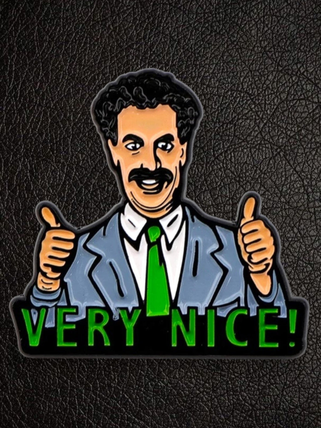 WILDSIDE Borat enamel pin with "Very Nice!" text and two thumbs up. Features a grey suit and green tie.
