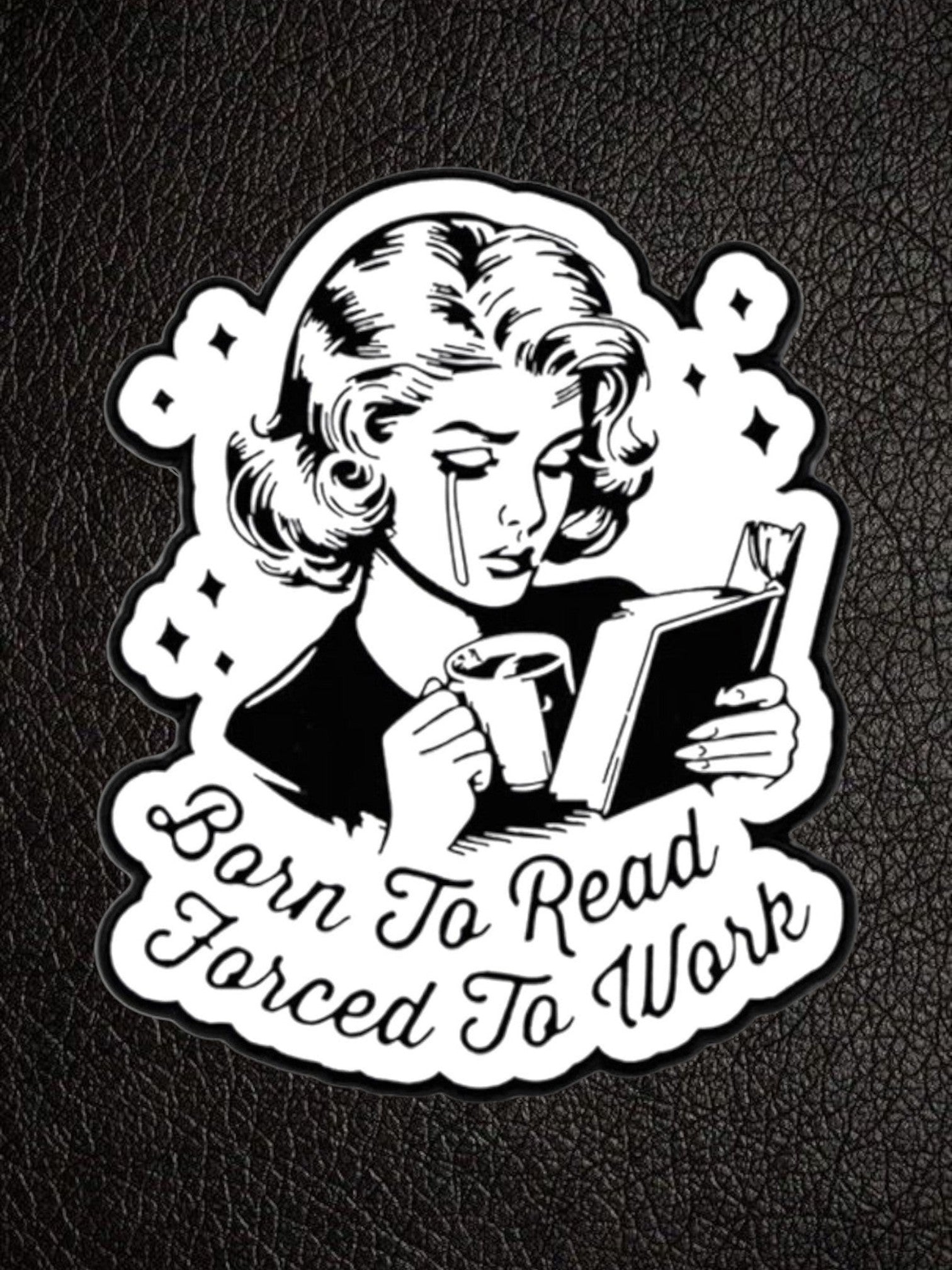 WILDSIDE black and white pin featuring a crying woman reading a book and holding a coffee cup, with text "Born To Read Forced To Work".
