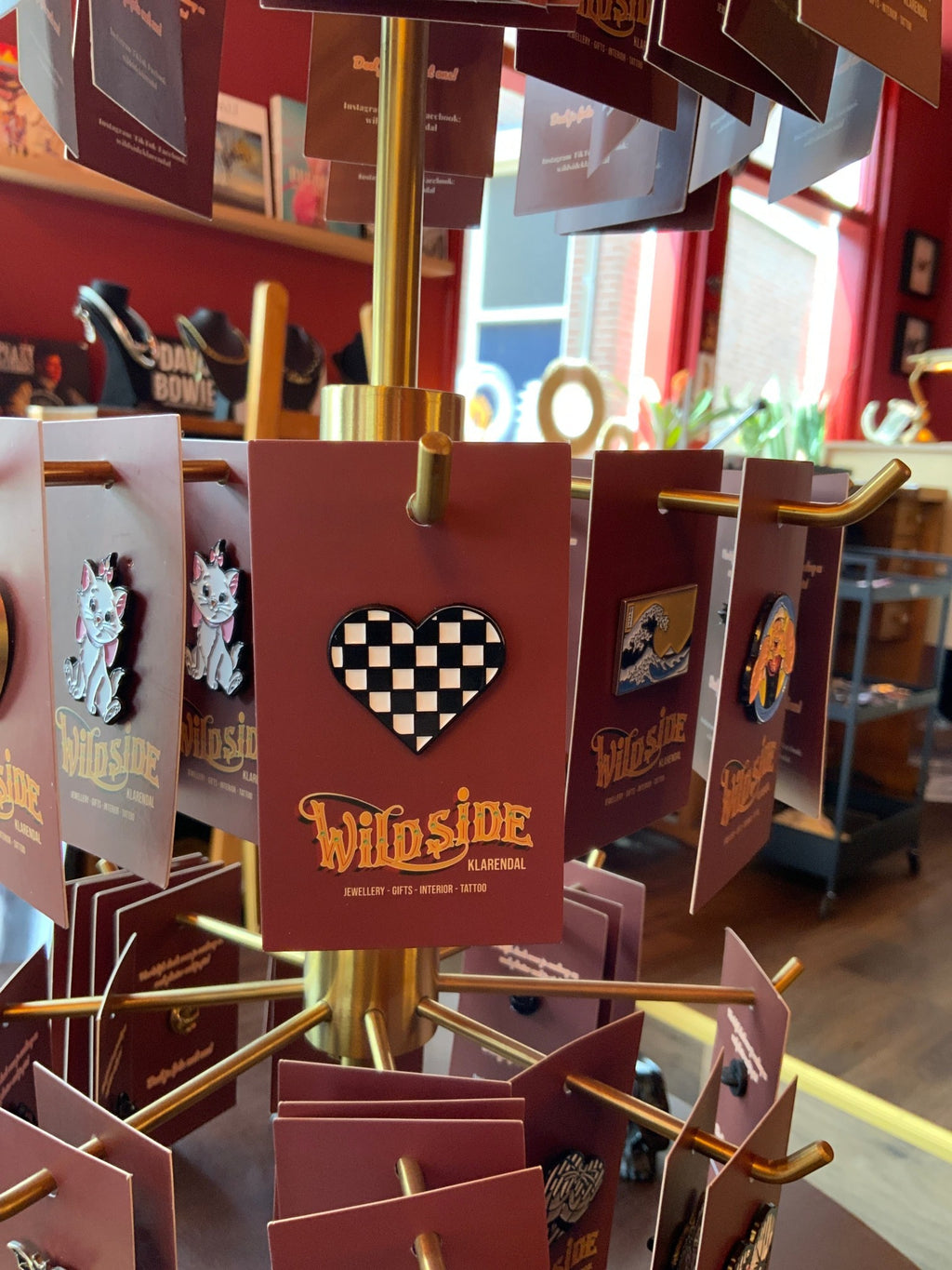 WILDSIDE checkerboard heart pin with black and white squares, enamel metal, perfect for jackets.