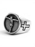 WILDSIDE silver-tone signet ring featuring a detailed crucifix centerpiece on a textured background with side cross motifs.