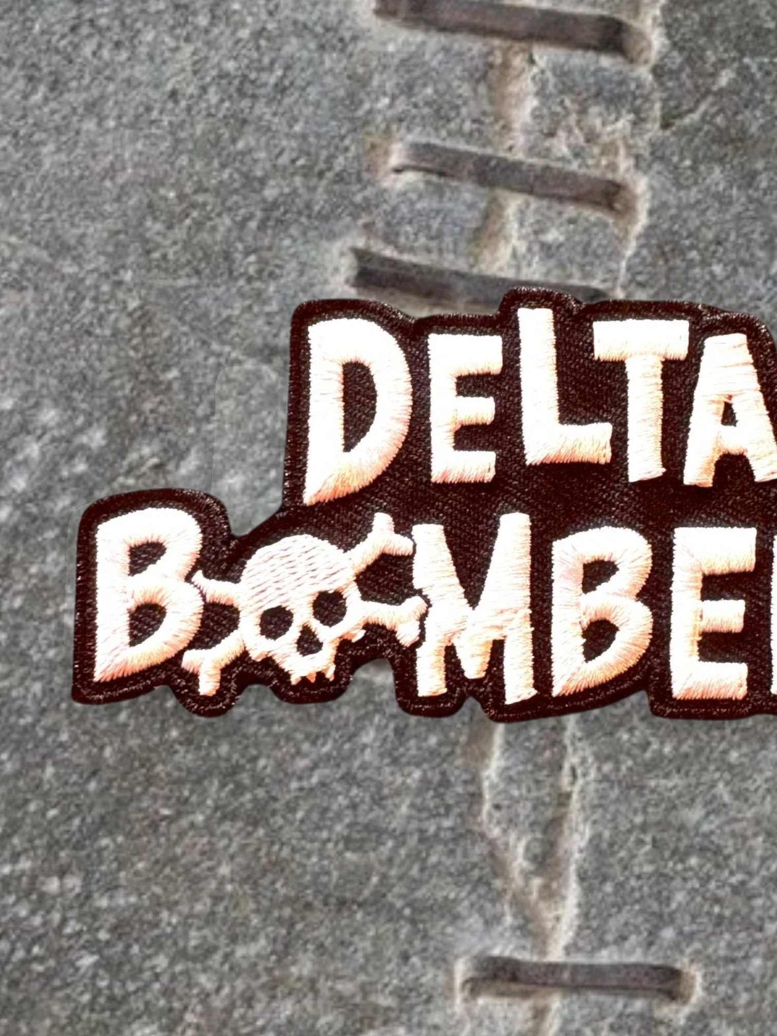 WILDSIDE Delta Bombers embroidered patch with skull detail, white and tan lettering on dark brown.
