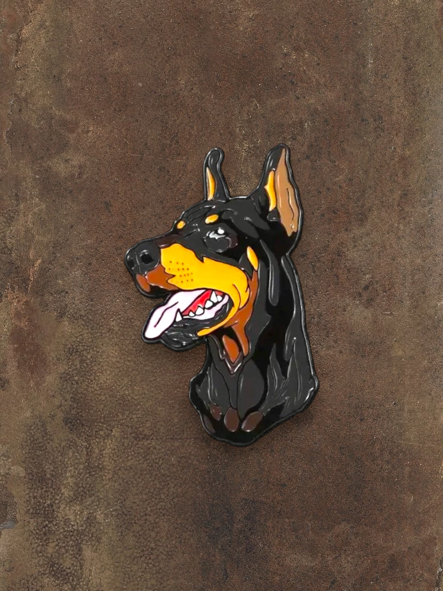 WILDSIDE Doberman dog enamel pin with black, tan, and yellow coloring, featuring a detailed head and tongue.