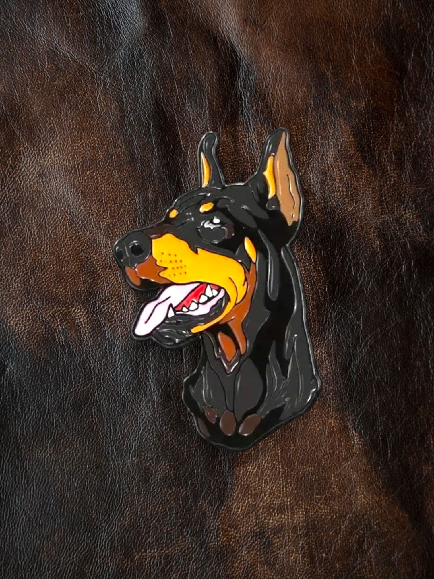 WILDSIDE Doberman dog enamel pin with black, tan, and yellow coloring, featuring a detailed head with tongue out.
