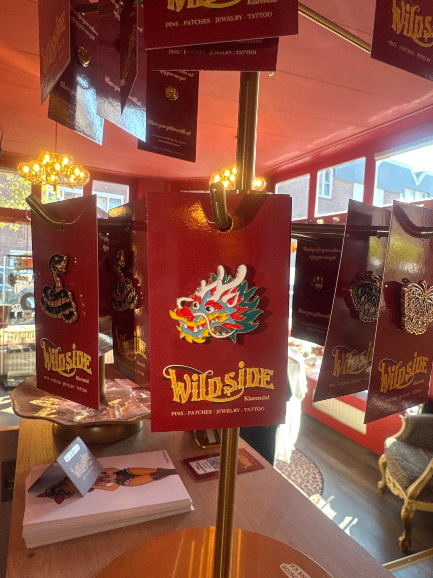 WILDSIDE dragon enamel pin with red, blue, green, yellow, and white details. Perfect for jackets and bags.