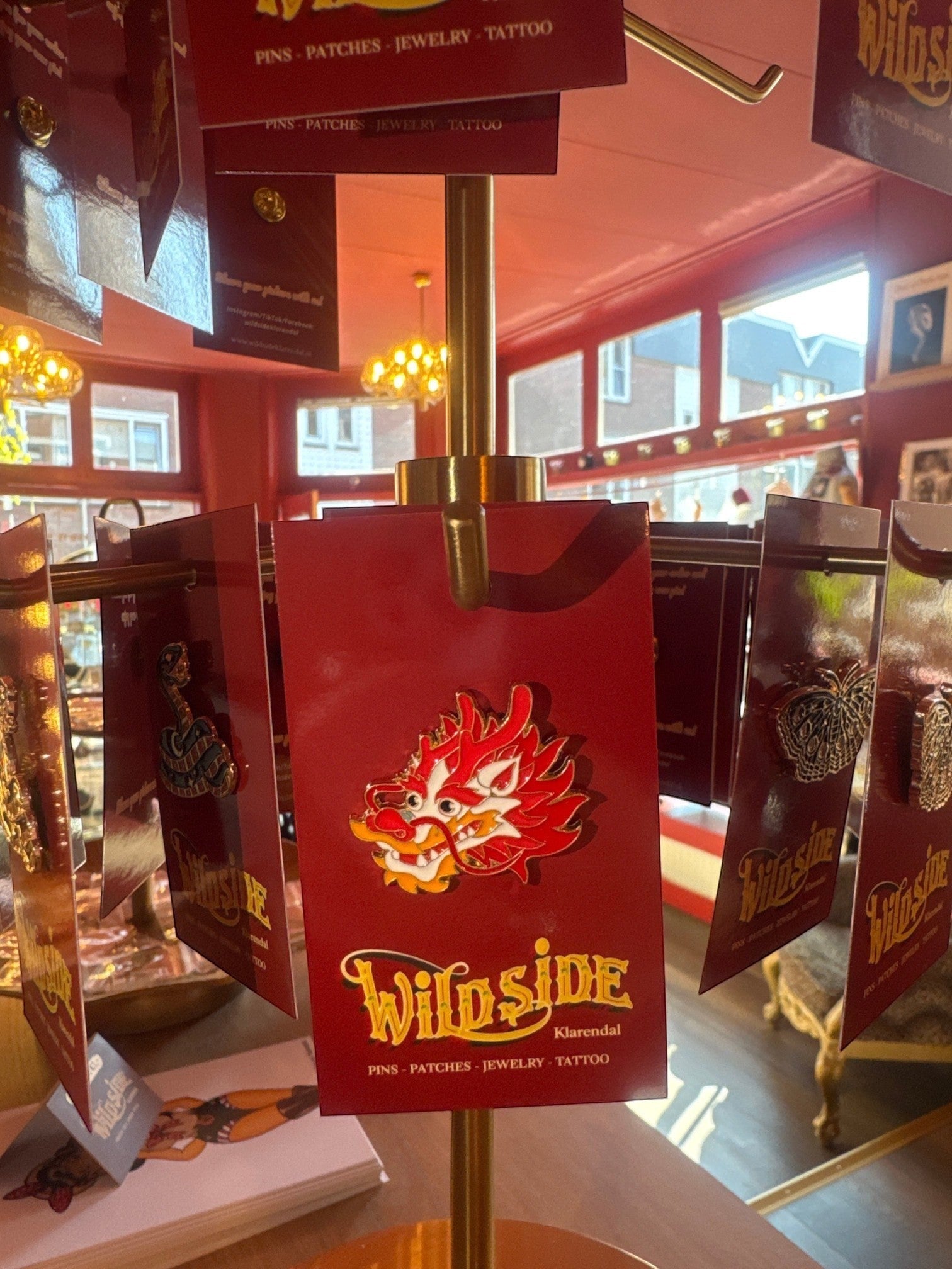 WILDSIDE red and white dragon enamel pin with gold trim. Perfect for jackets and bags.