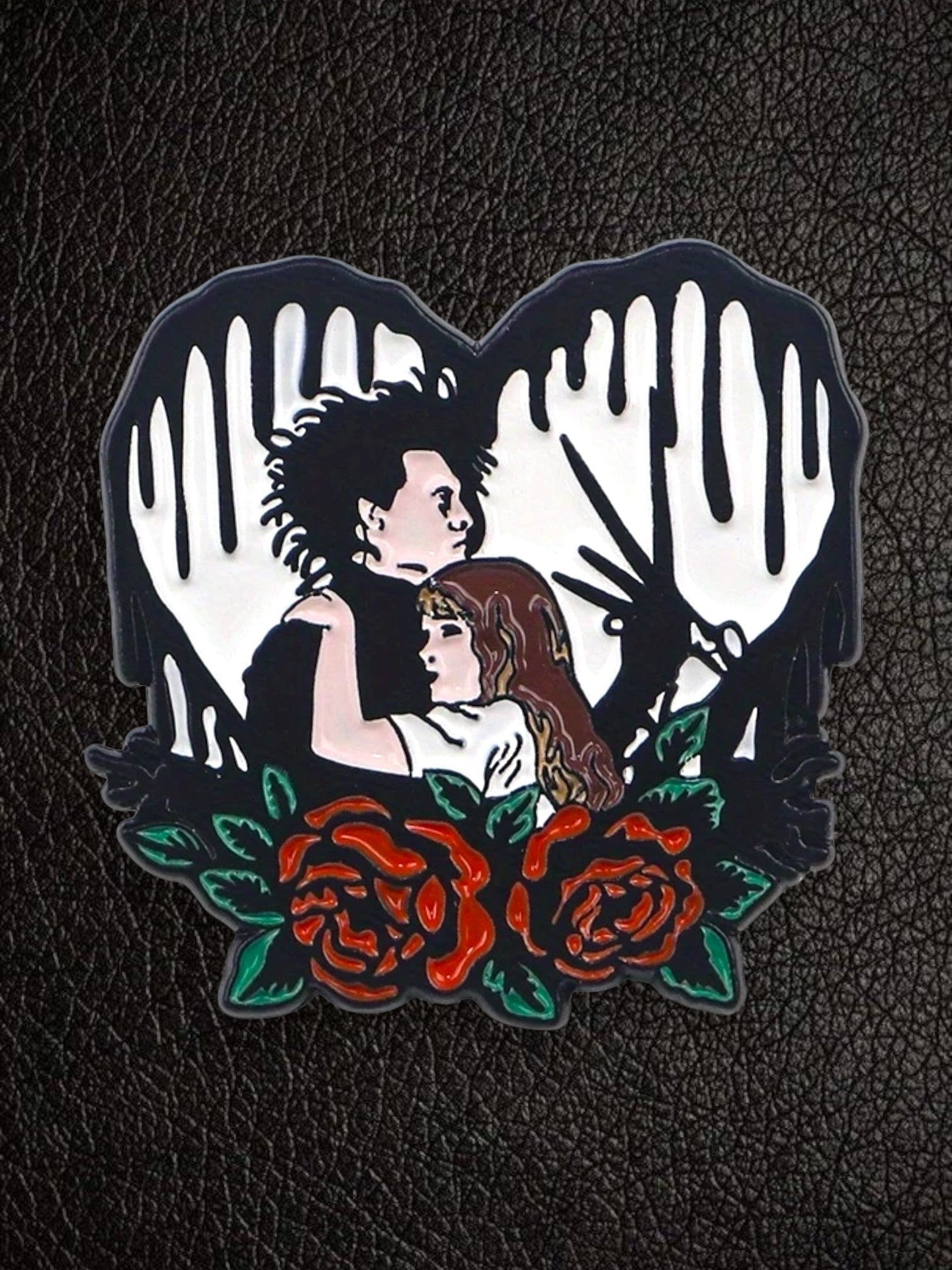 WILDSIDE Edward Scissorhand and Kim Boggs enamel pin with red roses and black dripping heart.