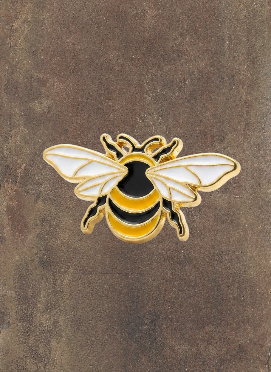 WILDSIDE gold-tone enamel bee lapel pin with black and yellow stripes and white wings.