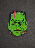 WILDSIDE Frankenstein monster enamel pin, green face with black hair, red stitches and bolts.