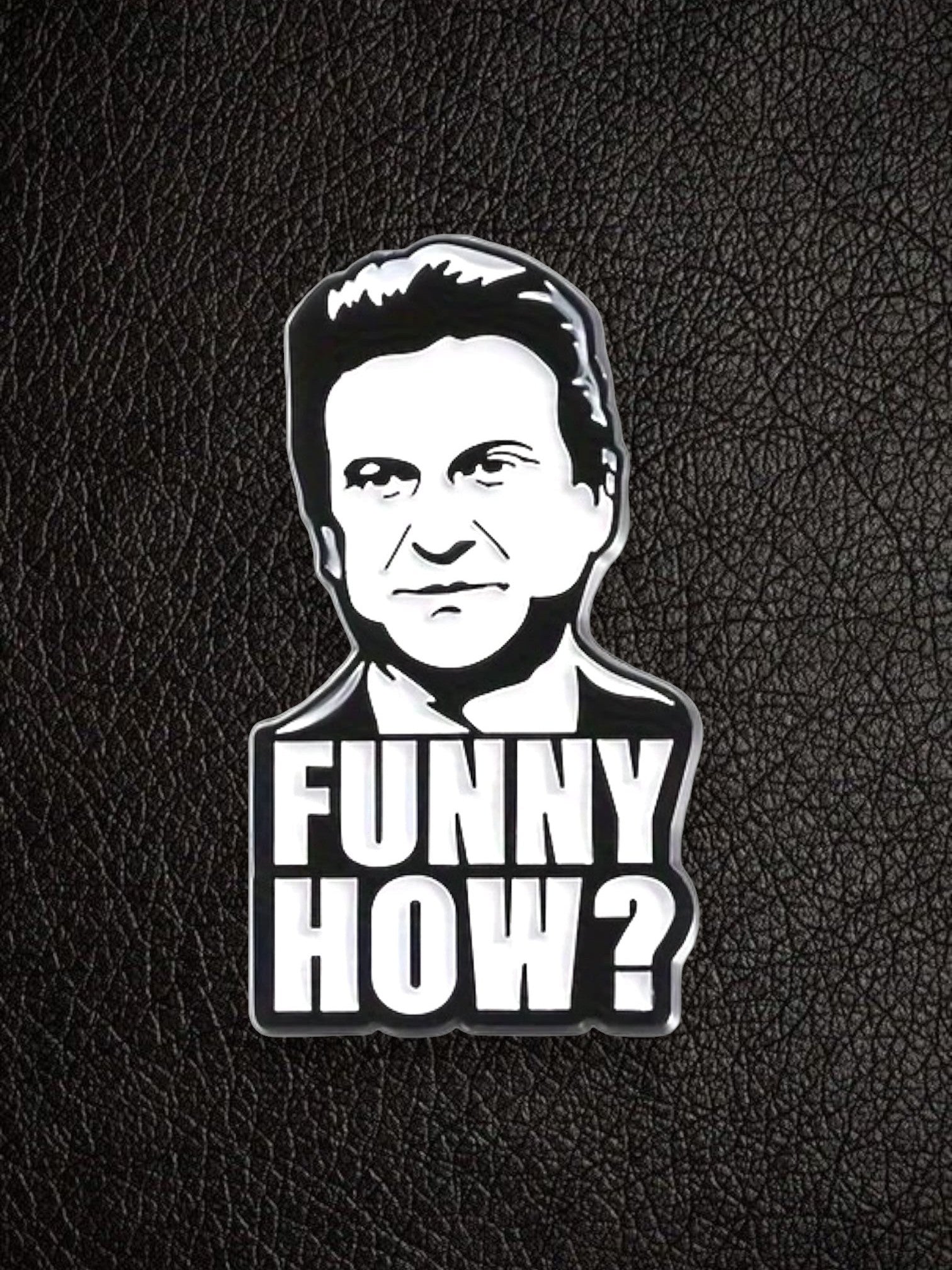 WILDSIDE black and white enamel pin featuring a portrait of a comedian with the text "FUNNY HOW?"