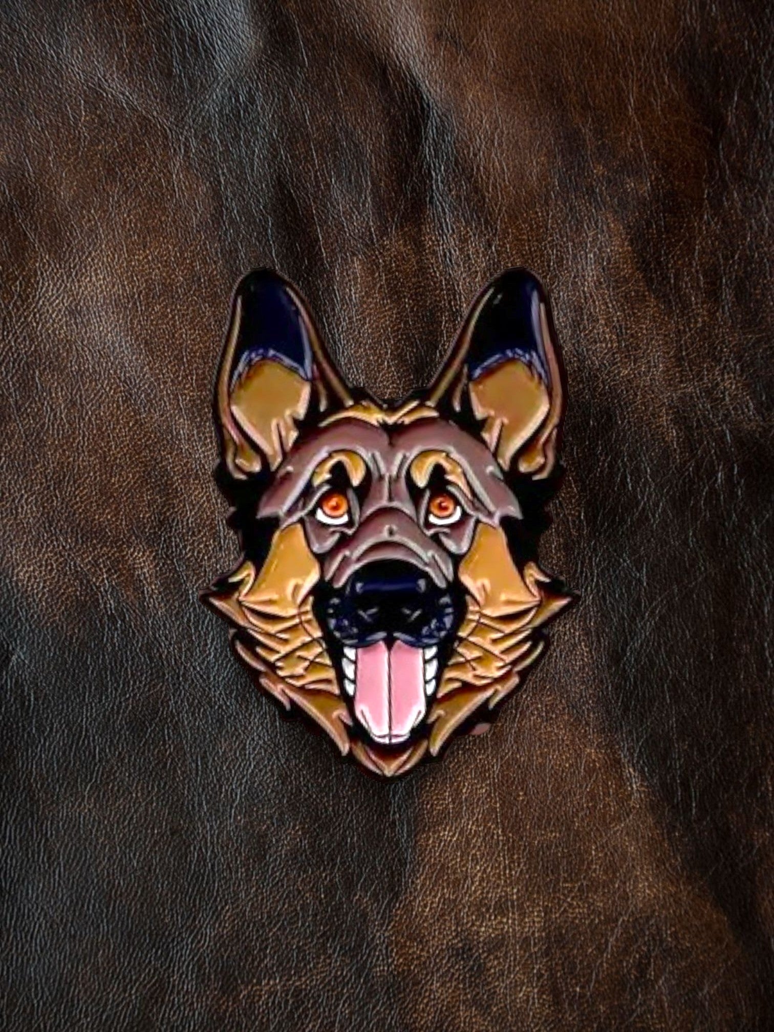 WILDSIDE German Shepherd dog enamel pin with detailed face, open mouth, and pink tongue on a brown textured background.