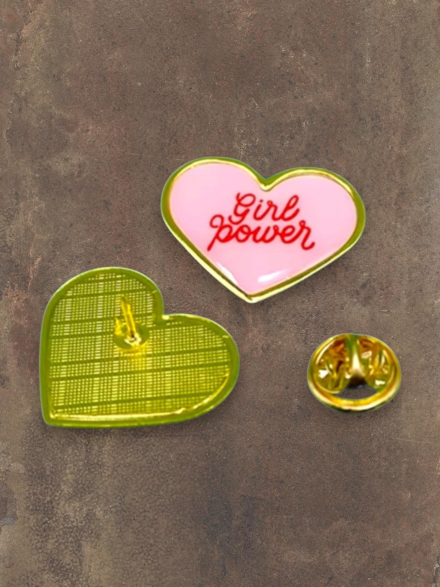 WILDSIDE pink heart enamel pin with red 'Girl power' text and gold trim. Back view shows green textured design.